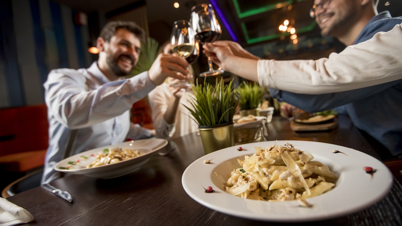 Young people having dinner in the restaurant