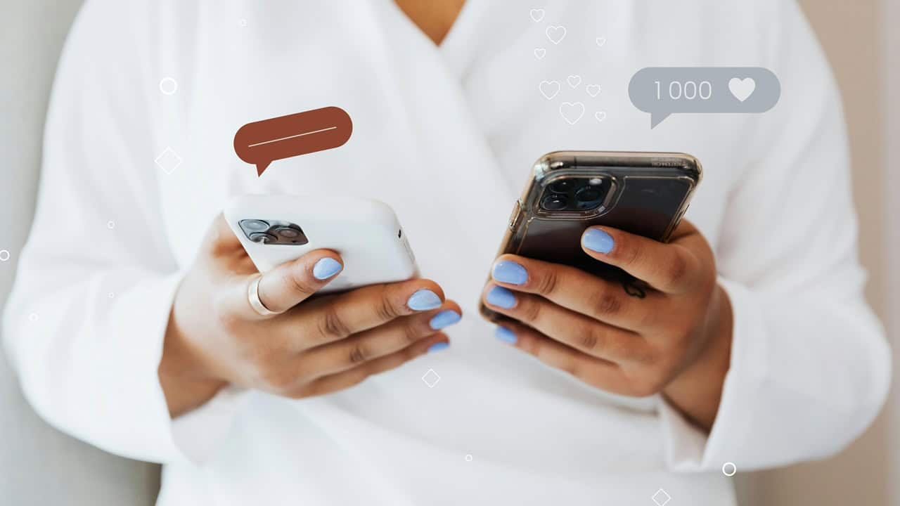 Why Is White Kratom Trending On Google Searches This Year? Alt text: Person holding two smartphones with social media icons, promoting digital wellness and mindful technology use.