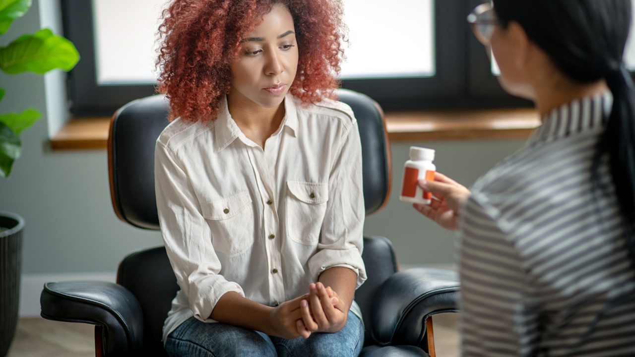 Curly young woman suffering from emotional disorder