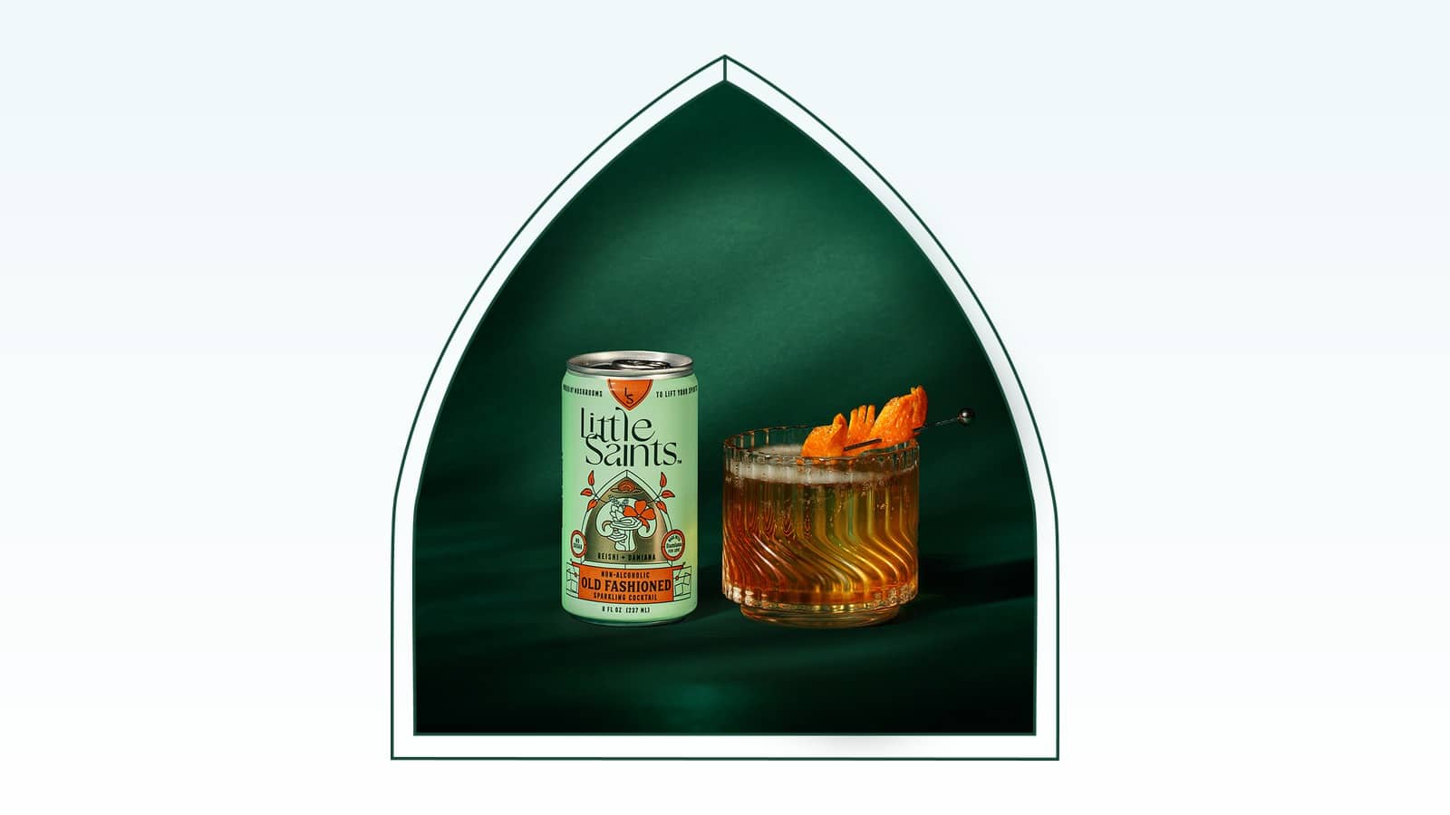 Little Saints Old Fashioned non alcoholic sparkling cocktail can with a poured cocktail and orange peel